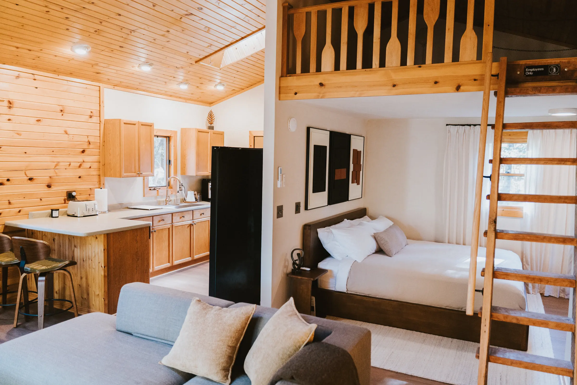 Pine-clad living room with a ladder to the sleeping loft