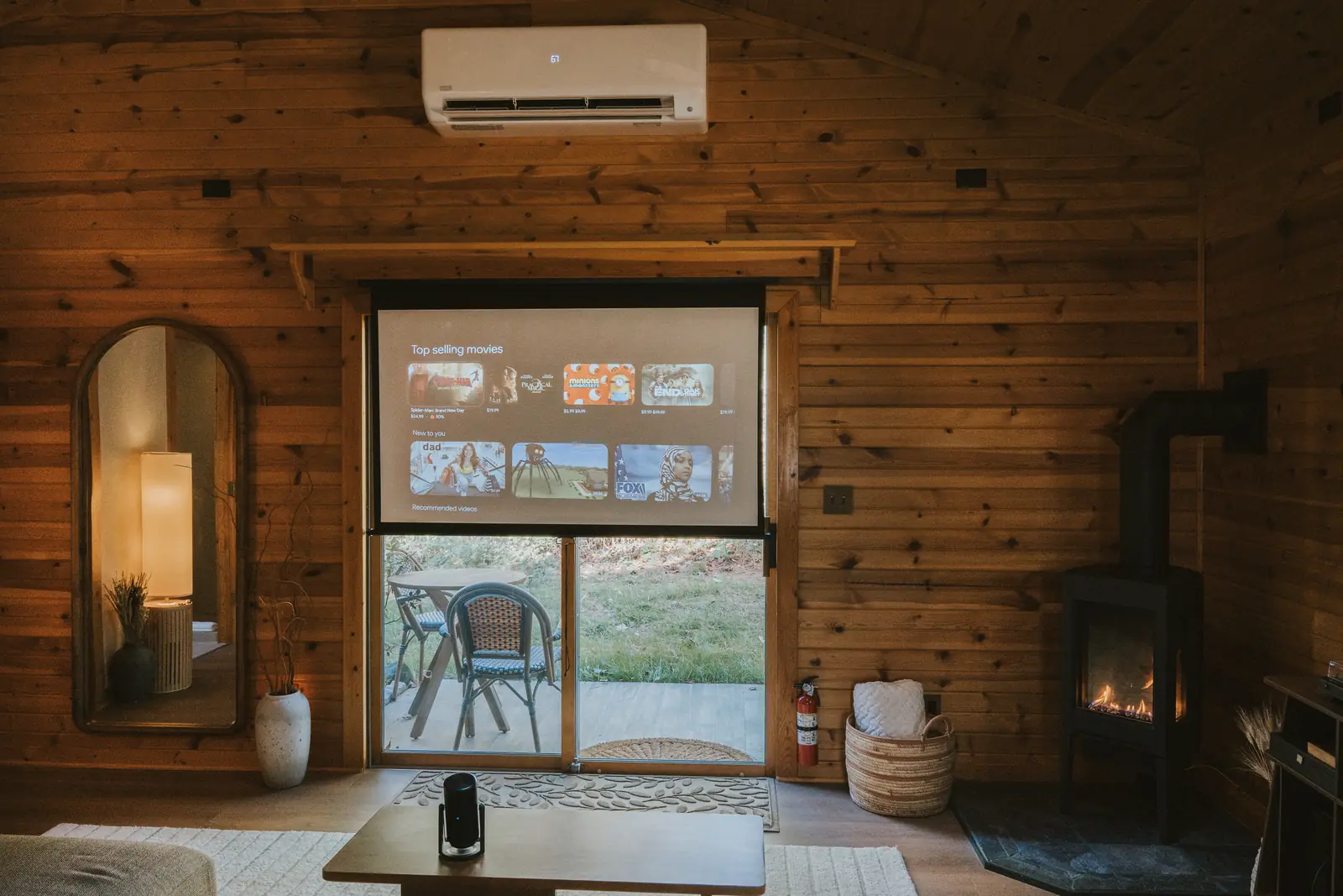 Projection screen lowered over the patio doors, stove lit