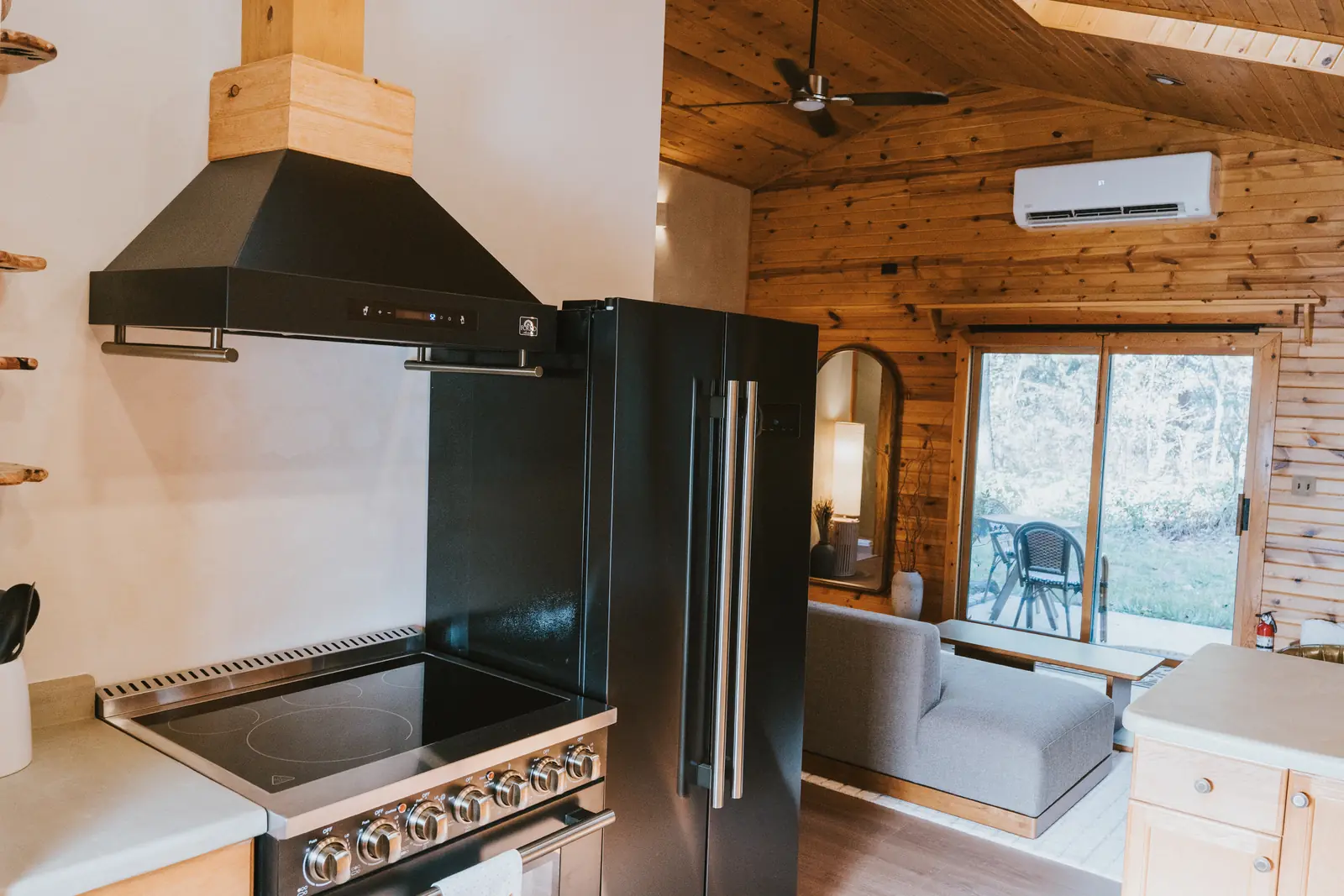 Pine-clad kitchen with range hood, open to the living room