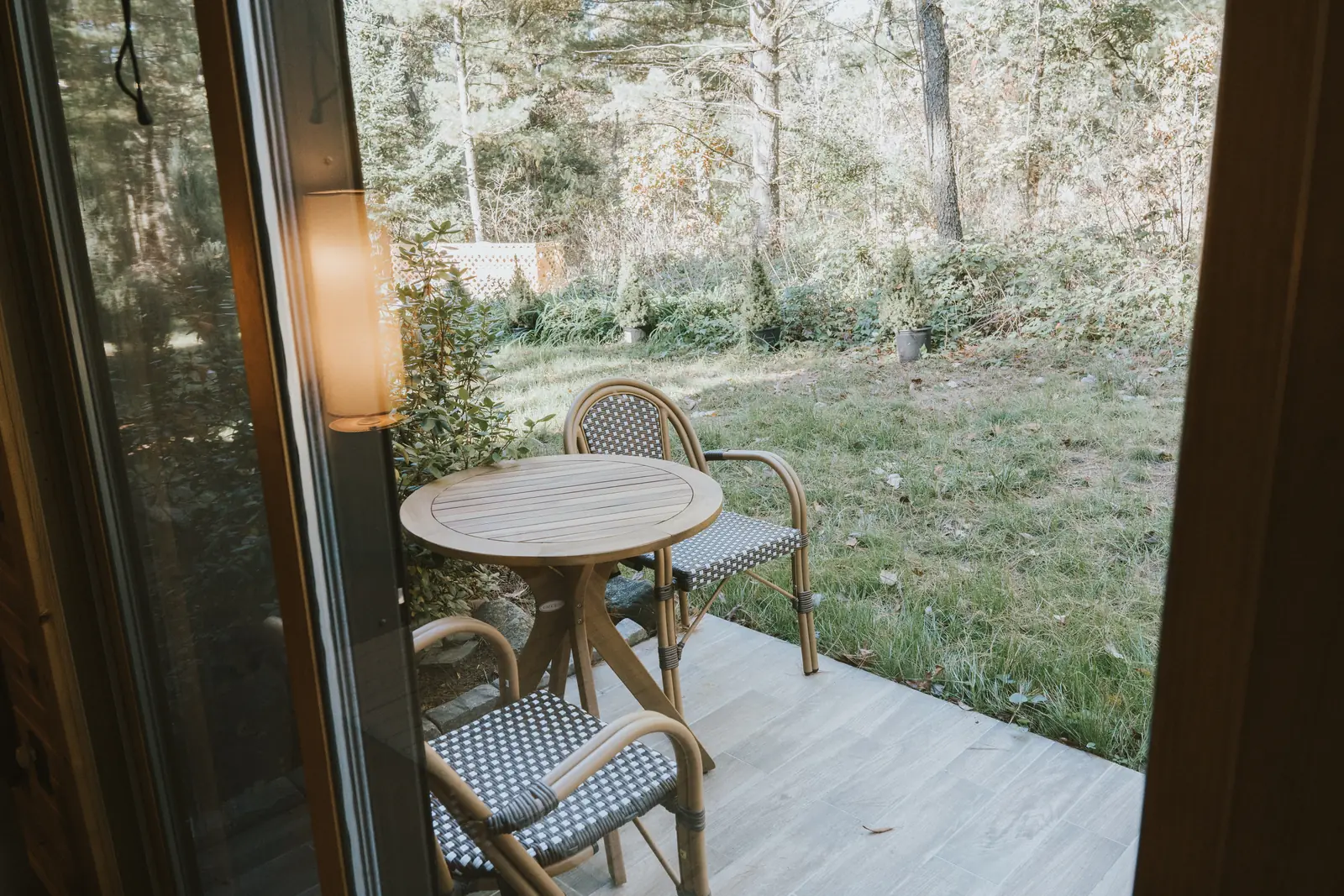Bistro table and chairs on the patio, seen from inside
