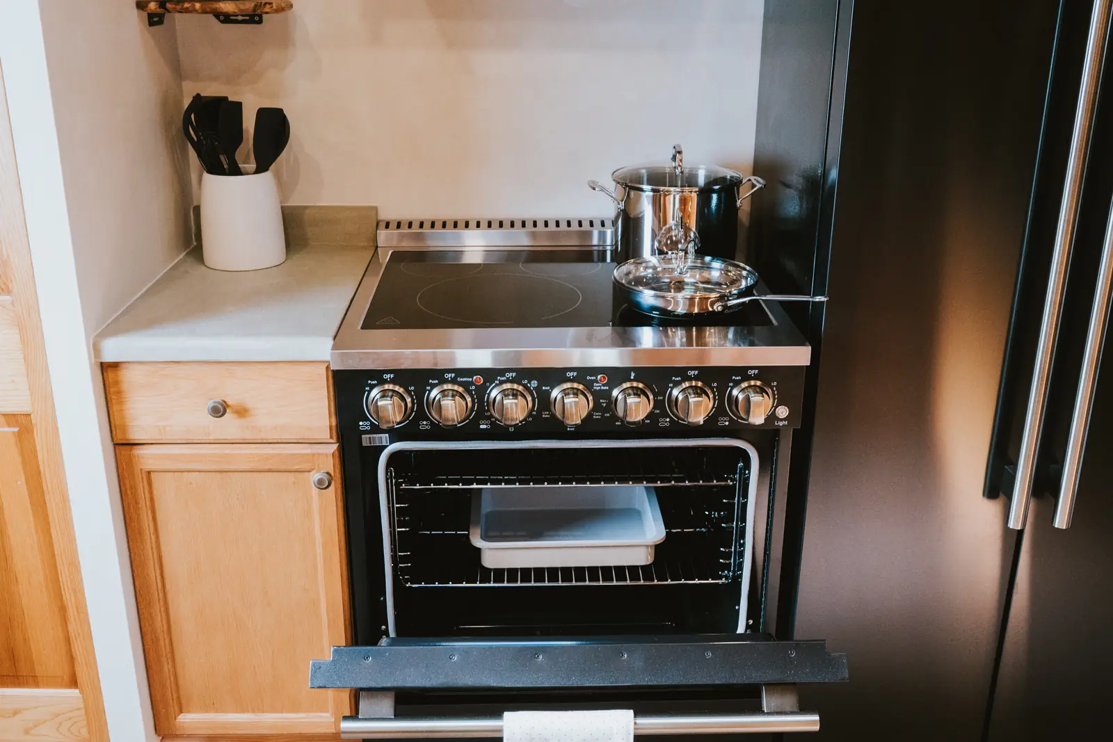 Black range and hood against warm plaster