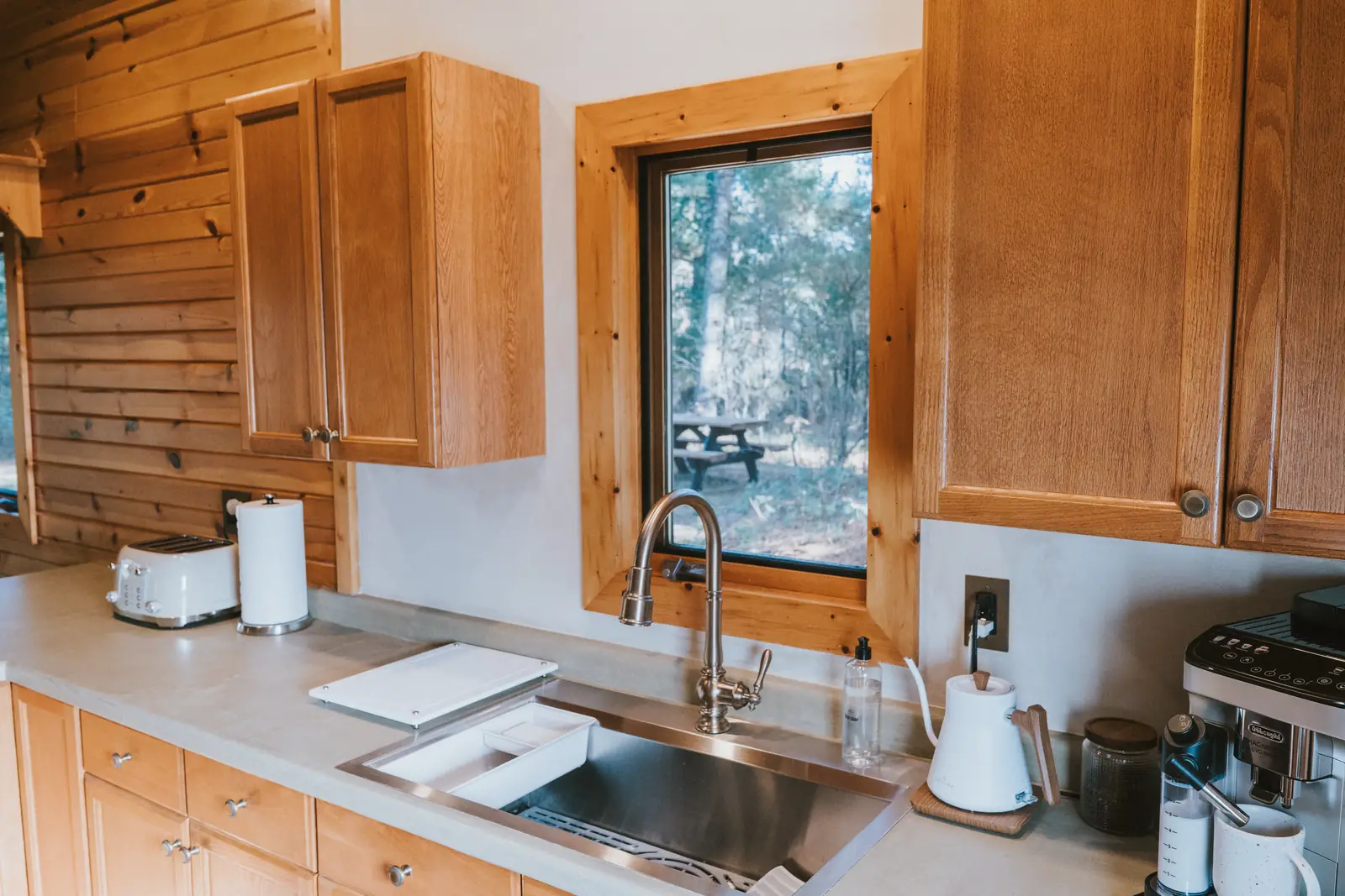 Kitchen sink under a pine-framed window
