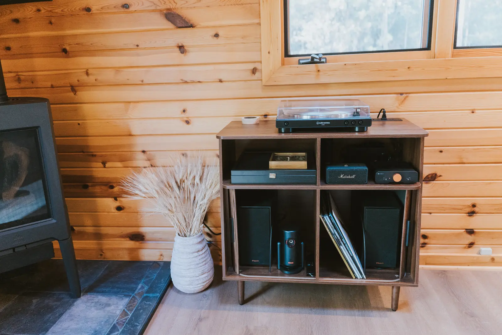 Record player and speakers on a walnut console