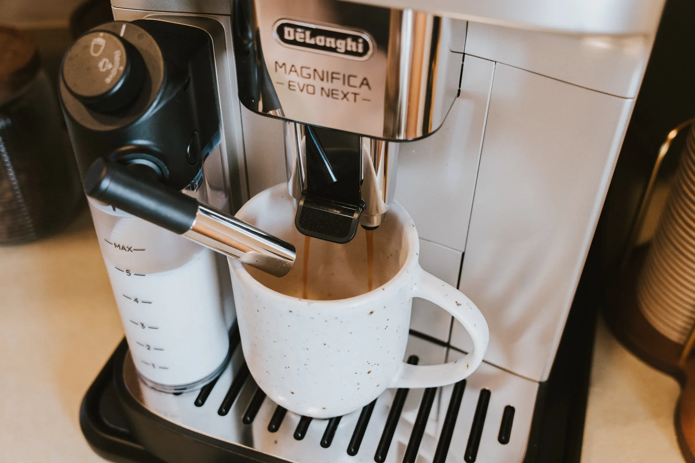 Coffee pouring from the machine into a white cup