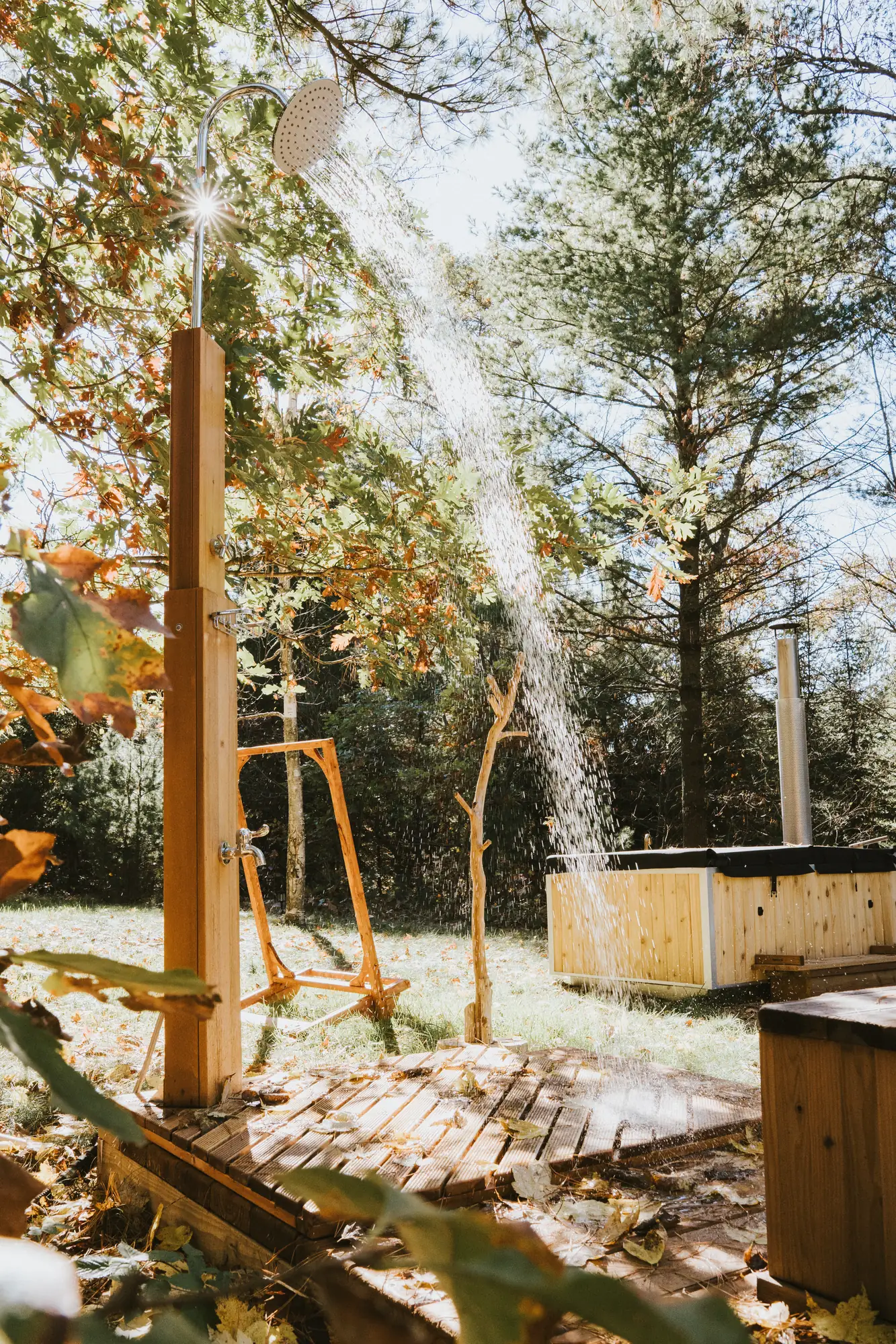 Cold outdoor shower running beneath the pines